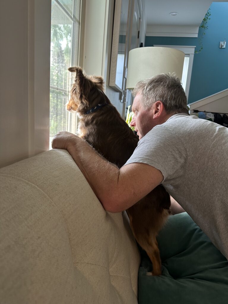 Byron on neighborhood watch at the front window with Cameron