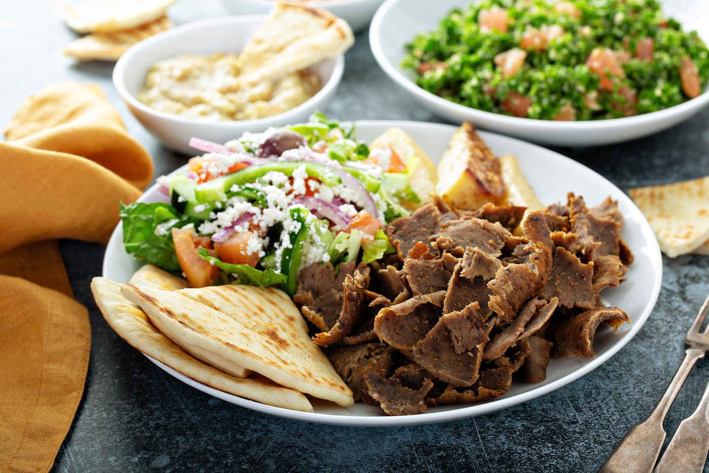 Greek platter with gyro meat, feta, pita, and salad at Aegean in Miramar Beach