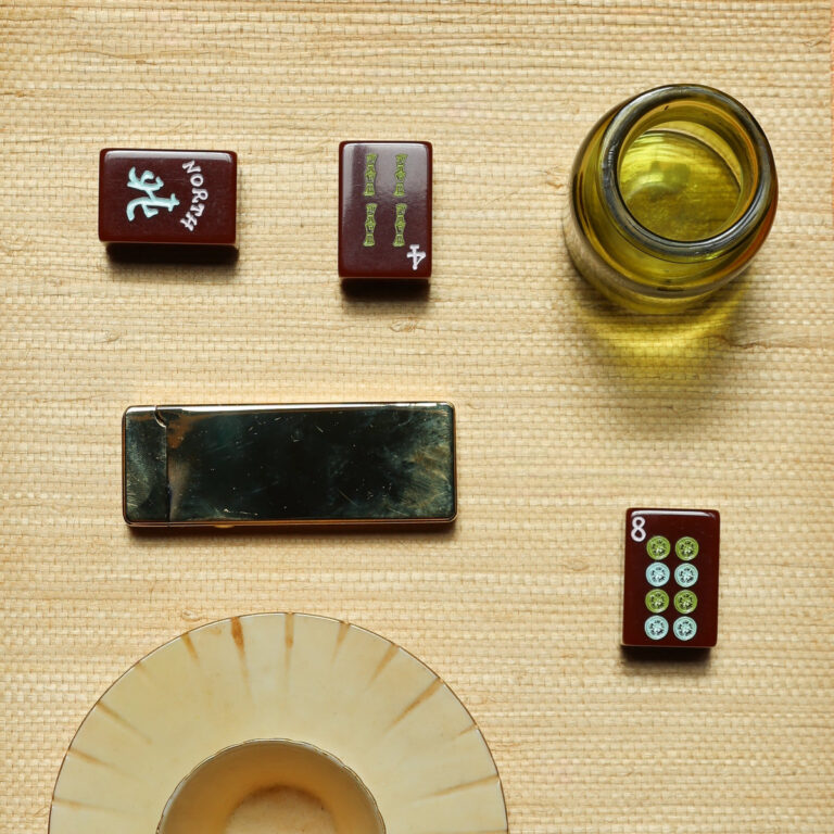 Brooklyn Mahjong Remsen mahjong tiles styled on a grasscloth table