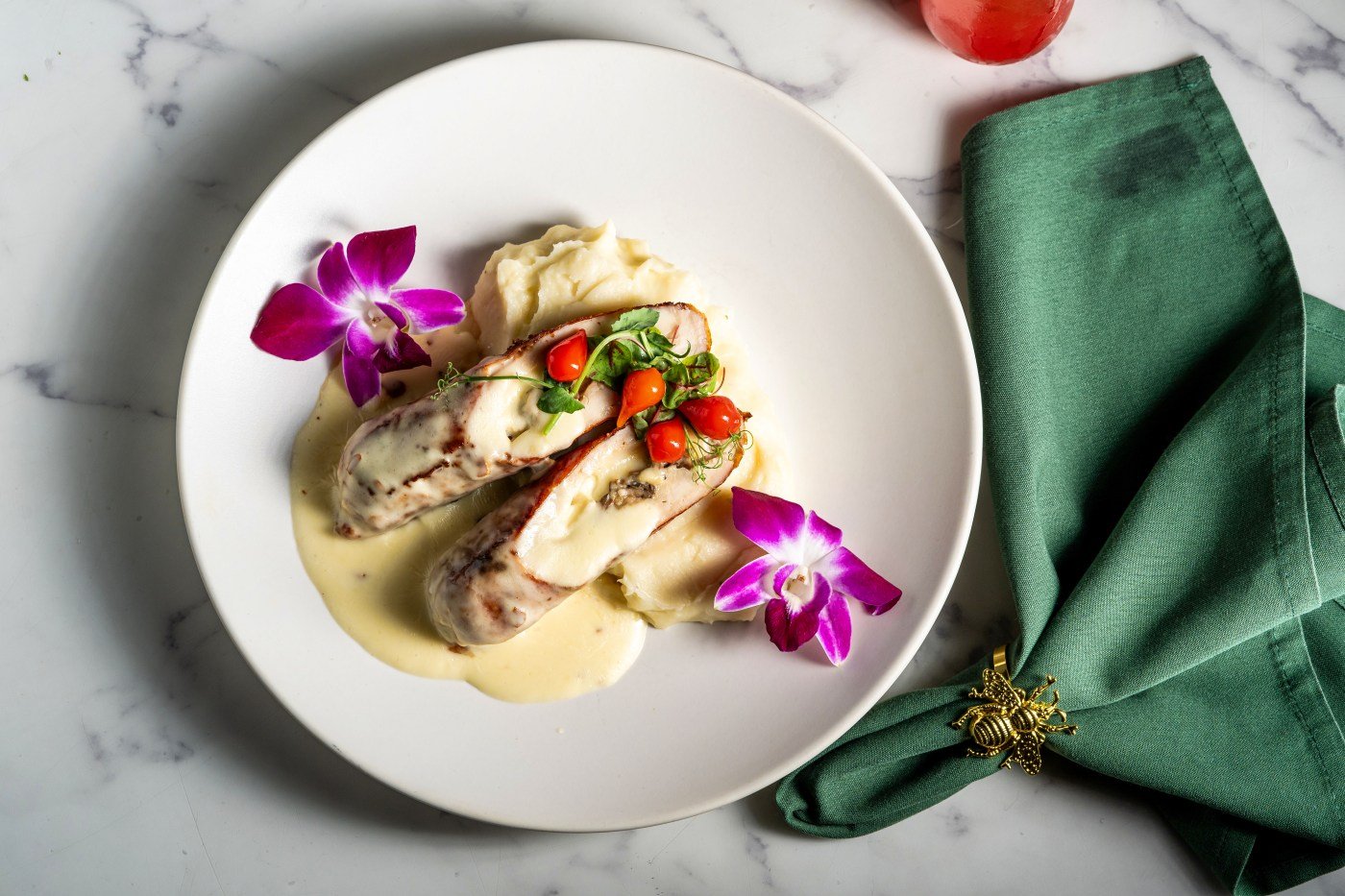 Plated pasta with edible flowers at Commelfo in Miramar Beach