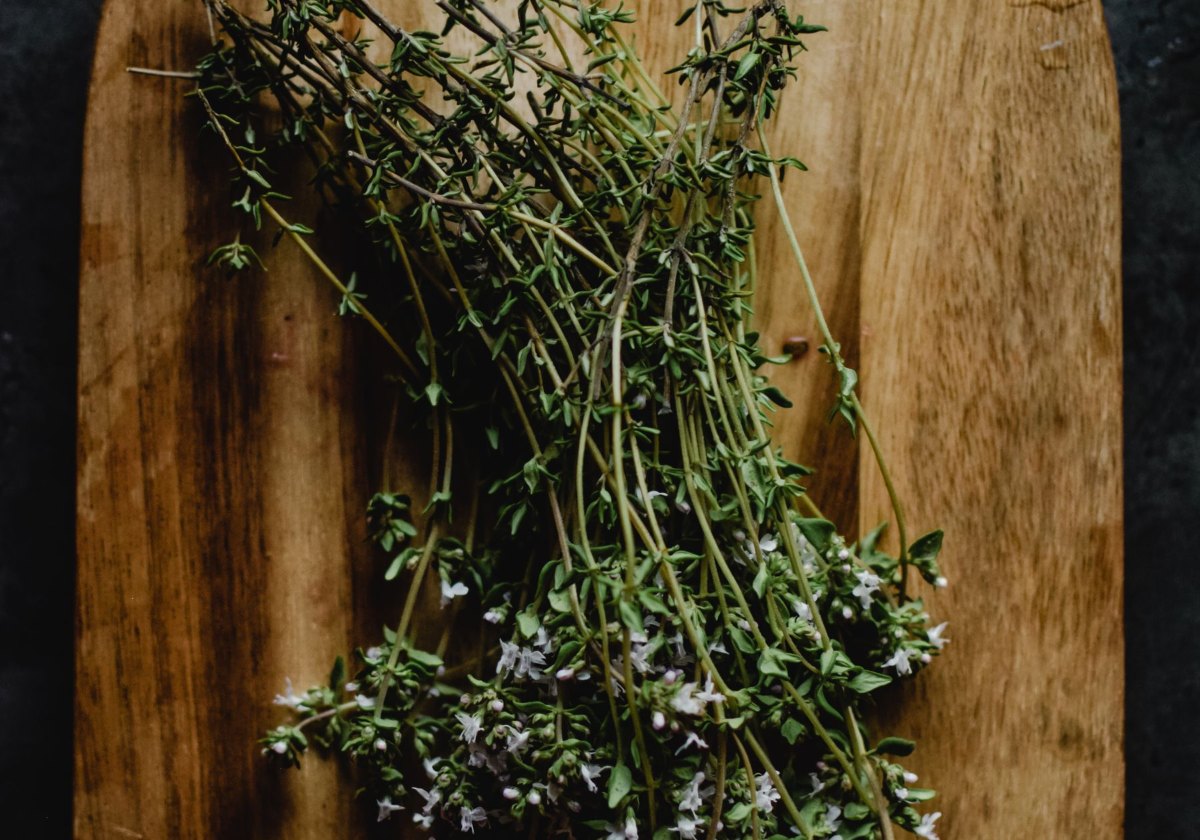 Fresh thyme sprigs on a wooden cutting board
