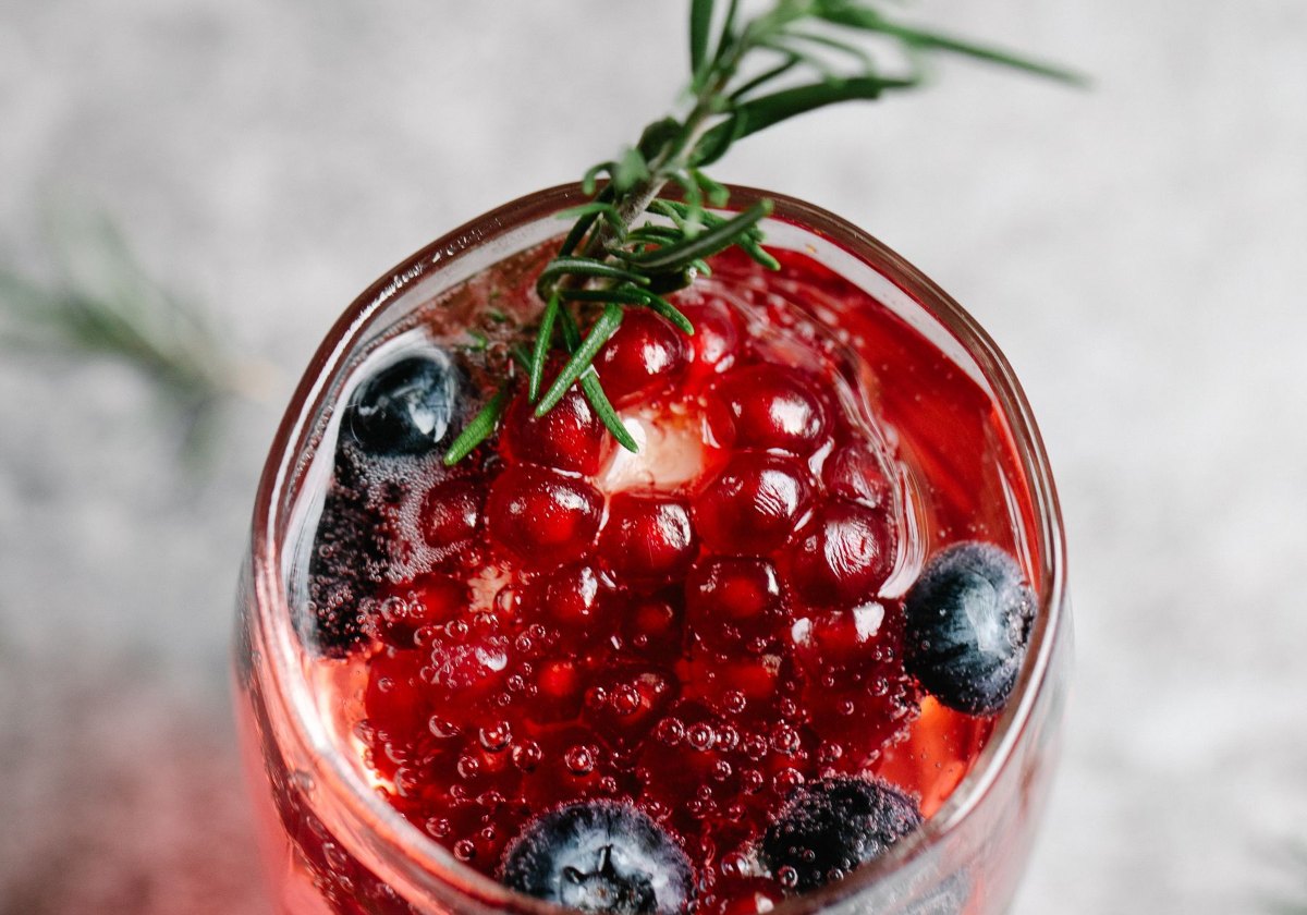 Cranberry rosemary shrub mocktail garnished with fresh cranberries and rosemary