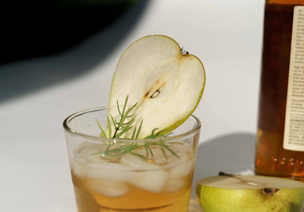 Pear ginger shrub mocktail with a pear slice and rosemary