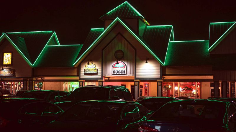 McGuire’s Sushi storefront lit up at night in Destin, Florida