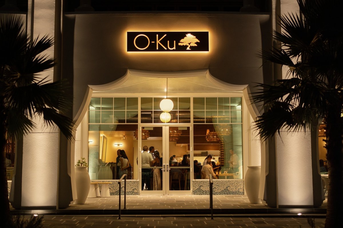 O-Ku sushi restaurant entrance lit up at night in Alys Beach, Florida